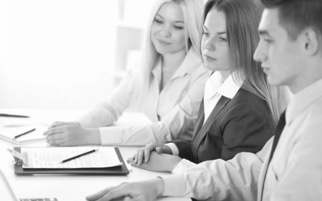 Financial planning workspace with notebooks and learning materials spread across desk